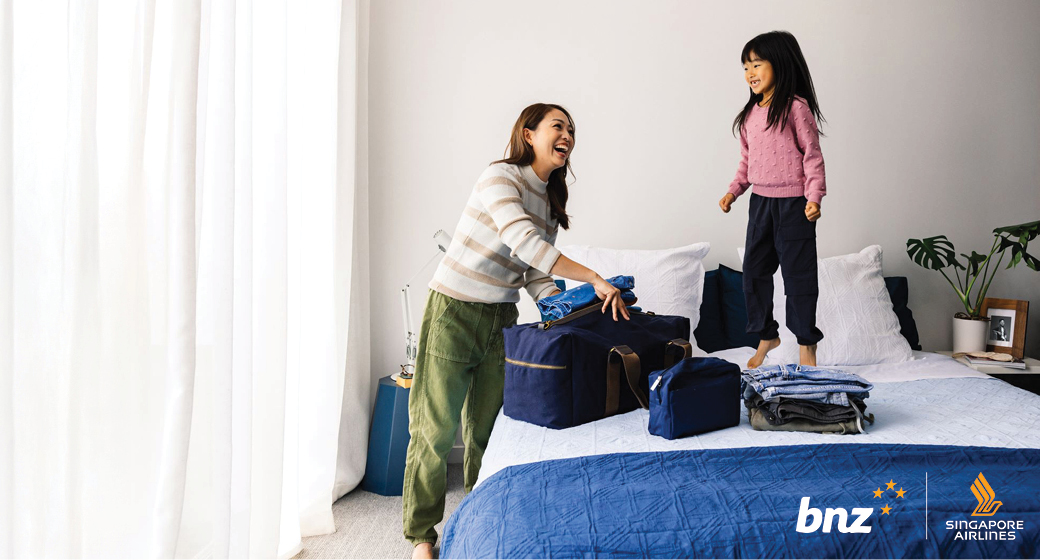 BNZ lady packing bags girl jumping on bed